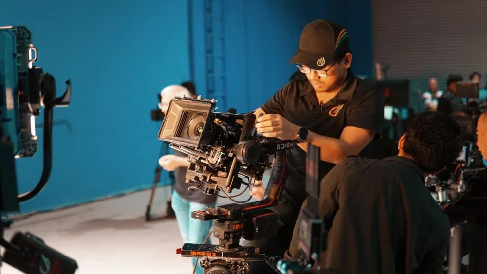 Production crew preparing a cinema camera and stabilizer for filming